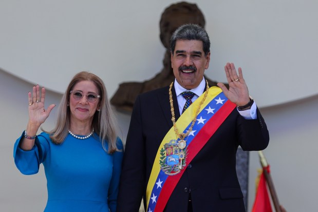 President of Venezuela Nicolas Maduro and his wife Cilia Flores hold hands and pose for photos after the swear-in ceremony at Palacio Federal Legislativo on January 10, 2025 in Caracas, Venezuela. (Photo by Jesus Vargas/Getty Images)