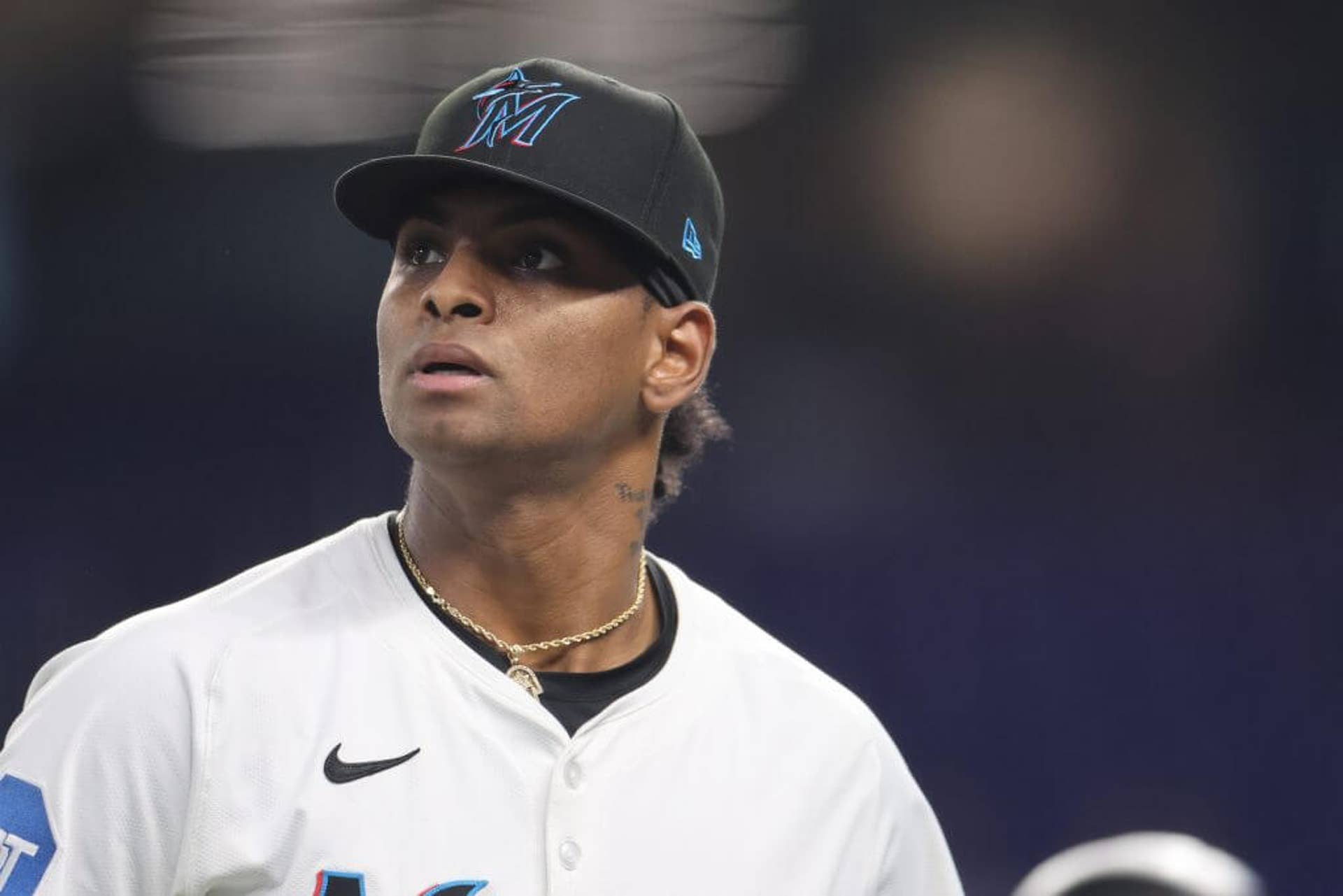 Edward Cabrera looks to his right while wearing a Marlins cap.