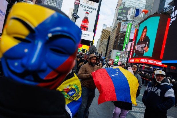 Venezuelans gather in Times Square following the United States military operation against Nicolas Maduro in Venezuela at a resturant in New York City, NY, United States on January 3, 2026. (Photo by Jason Alpert-Wisnia / Hans Lucas / AFP via Getty Images)