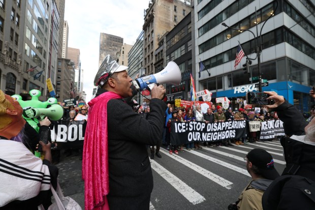 People participate in a protest against ICE activities and the US intervention in Venezuela.