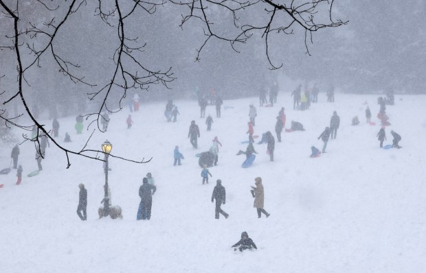 People go sledding in the snow at Cedar Hill in Central Park in New York City on January 25, 2026. A massive winter storm on January 24 dumped snow and freezing rain from New Mexico to North Carolina as it swept across the United States towards the northeast, threatening tens of millions of Americans with blackouts, transportation chaos and bone-chilling cold. After battering the country's southwest and central areas, the storm system began to hit the heavily populated mid-Atlantic and northeastern states as a frigid air mass settled in across the nation. (Photo by TIMOTHY A. CLARY / AFP via Getty Images)