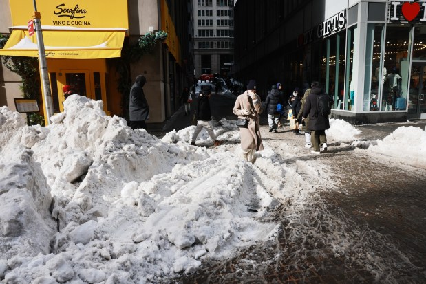 People walk through snow and ice covered streets as New York City experiences frigid temperatures following a winter storm over the weekend on Jan. 27, 2026, in New York City. (Photo by Spencer Platt/Getty Images)