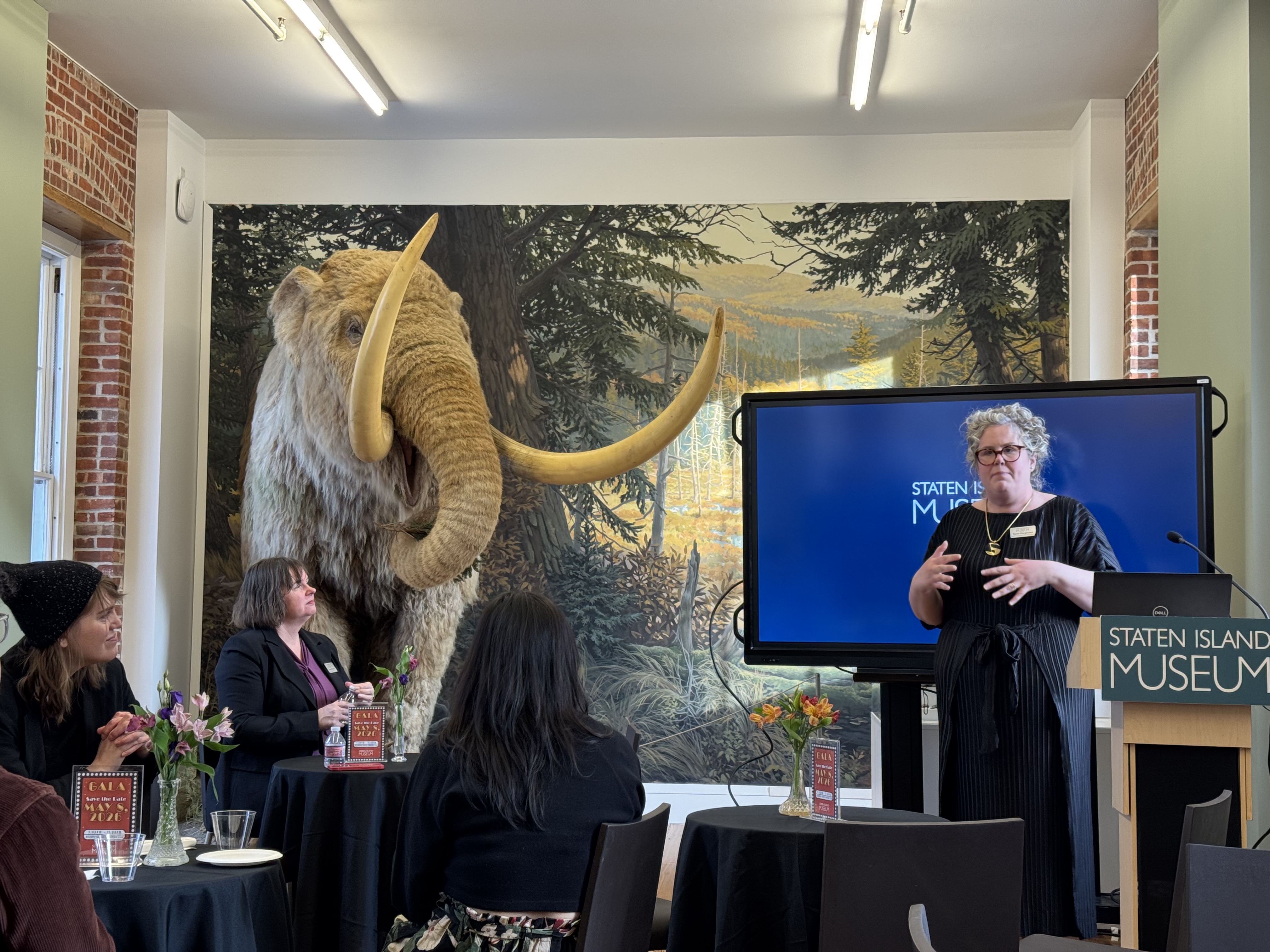 Rylee Eterginoso talks to artists and press at an exhibit preview on Thursday