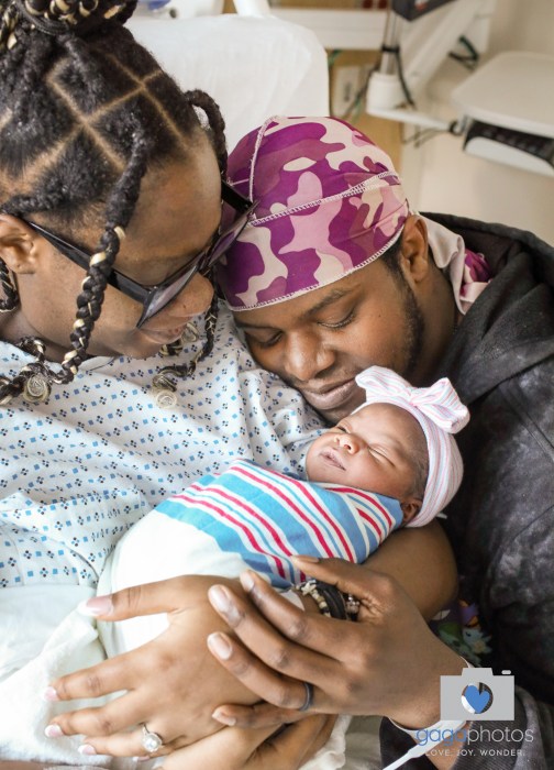 Parents Sanari Sherred and Michael Harrison (L. to R.) with their newborn on New Year's Day.