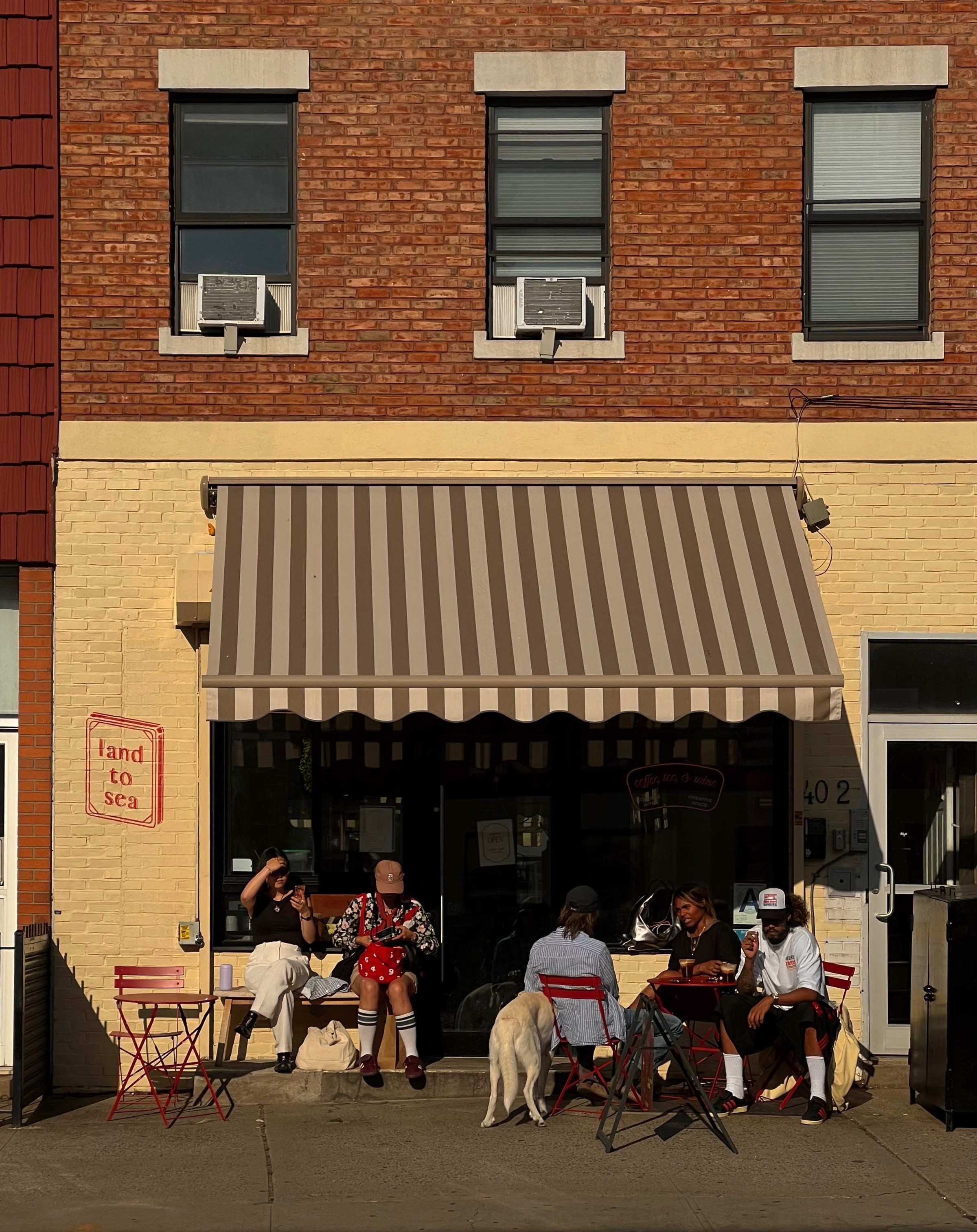 A restaurant facade with a striped awning.