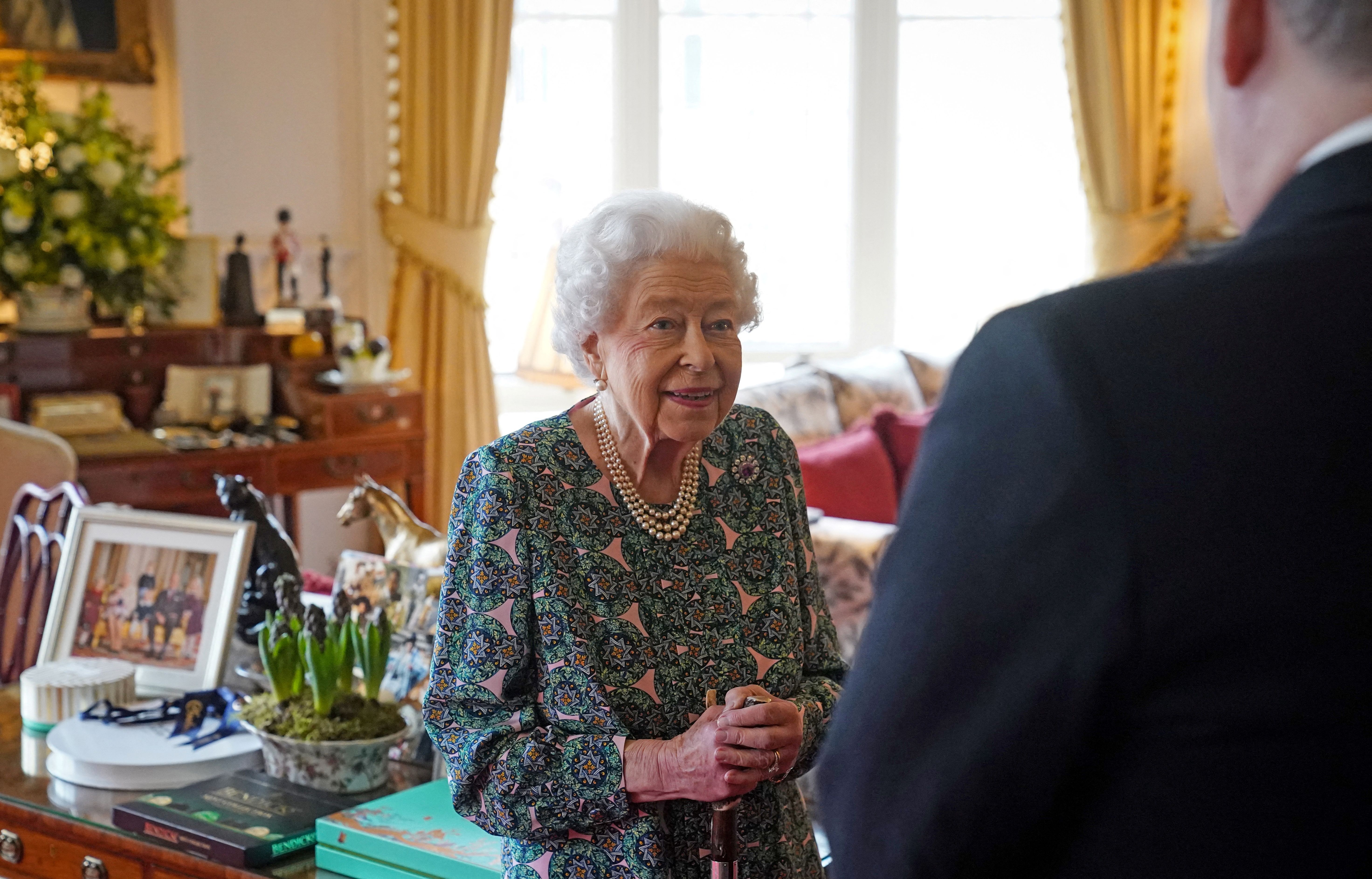 Queen Elizabeth II (L) speaks with incoming Defence Service Secretaries Major General Eldon Millar (R) during an in-person audience at the Windsor Castle, in Windsor, on February 16, 2022.