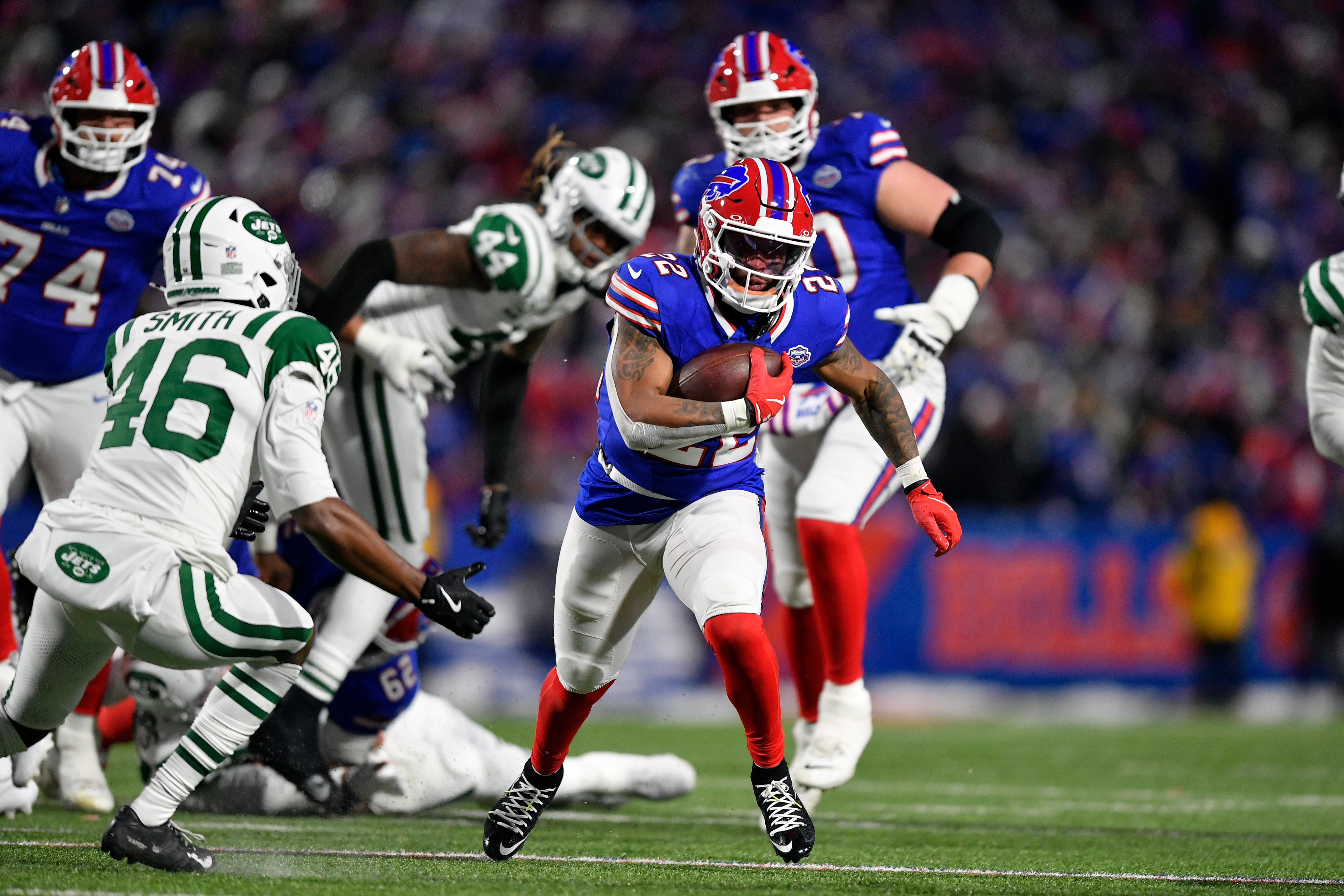 Buffalo Bills running back Ray Davis (22) carries the ball as New York Jets safety Keidron Smith (46) closes in during the first half of an NFL football game Sunday, Jan. 4, 2026, in Orchard Park, N.Y. (AP Photo/Adrian Kraus)