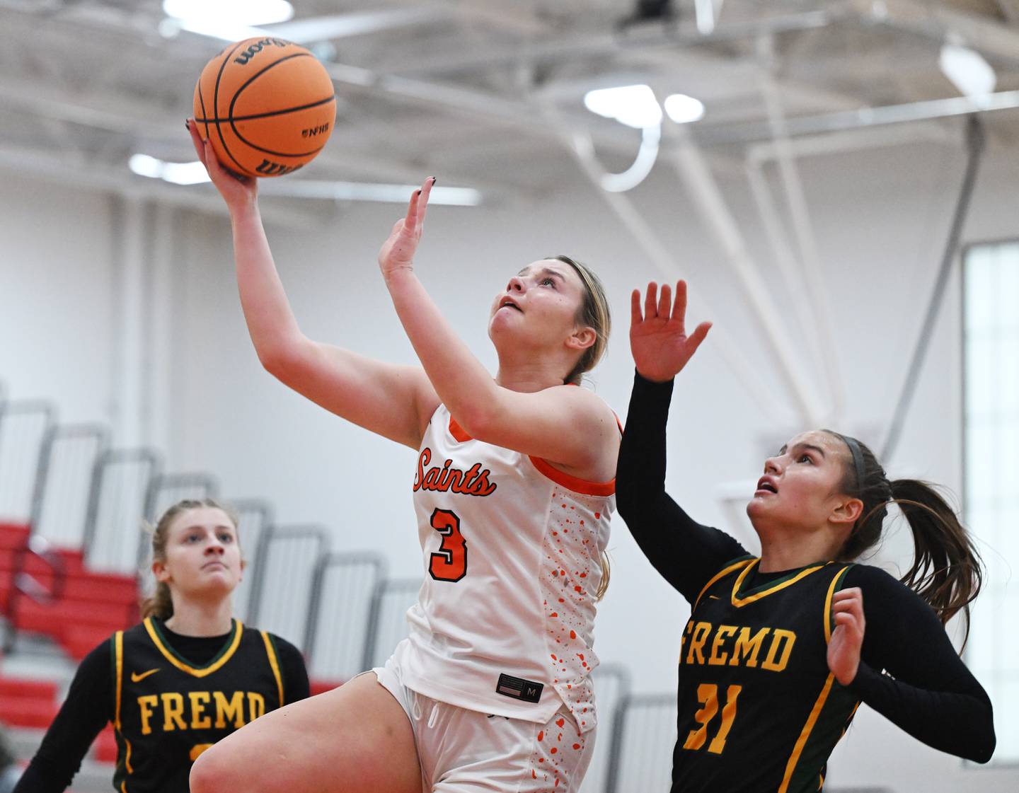 St. Charles East's Stella Trask, left, drives to the basket for a layup against Fremd's Isabella Del Mar during the Grow the Game Showcase at Deerfield High School on Saturday, Jan. 3, 2026 in Deerfield.