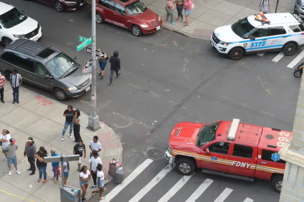 Police secure the scene on Aqueduct Ave. at W. 190th St. in the Bronx on Wednesday, Aug. 23, 2023. Eric Duprey, a scooter-riding suspect fleeing a Bronx buy-and-bust drug sting, was killed on Wednesday, Aug. 23, 2023, when an NYPD sergeant grabbed a cooler from a nearby family get-together and hurled it at the man, knocking him to the ground, an eyewitness and police sources said. (Sam Costanza for New York Daily News)