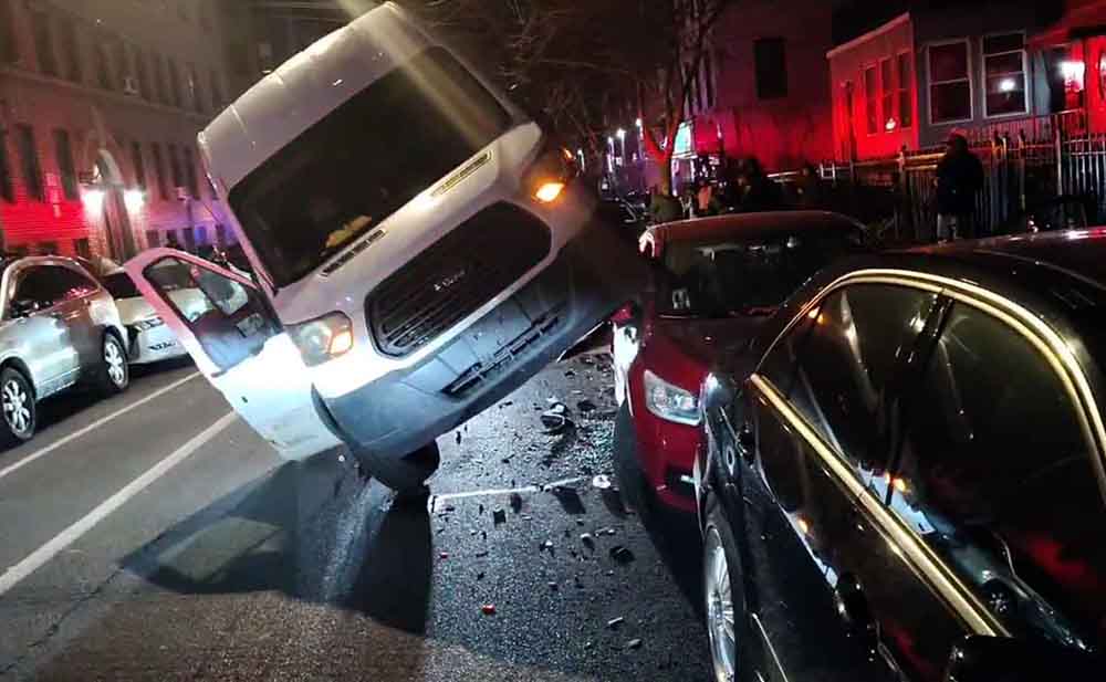 Norwood: No Injuries Reported as Truck Lands on Car After Hull Ave. Crash