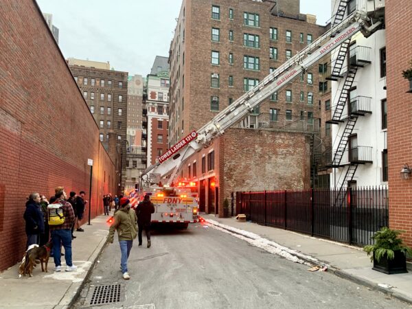 Residents watch from Love Lane as firefighters work on the rear of the 75 Pierrepont St. building. Photo: Mary Frost, Brooklyn Eagle