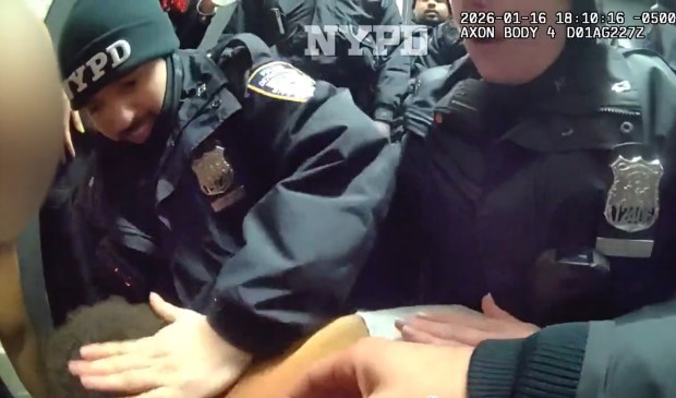 NYPD Officer Freddy Cerpa, left, and Officer Megan Ficken are pictured in body-cam footage performing CPR on an infant. (NYPD)