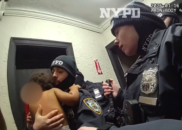 NYPD Officer Freddy Cerpa, left, and Officer Megan Ficken are pictured in body-cam footage performing CPR on an infant. (NYPD)