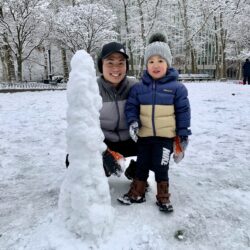 Brooklyn Heights resident Hunt Lau and his son Nate build a snowman in Cadman Plaza Park. Photo: Mary Frost, Brooklyn Eagle