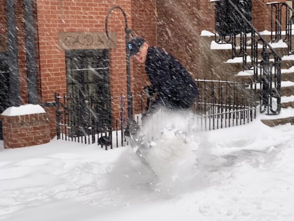 A Brooklyn Heights resident puts his back into shoveling his sidewalk. Photo: Mary Frost, Brooklyn Eagle