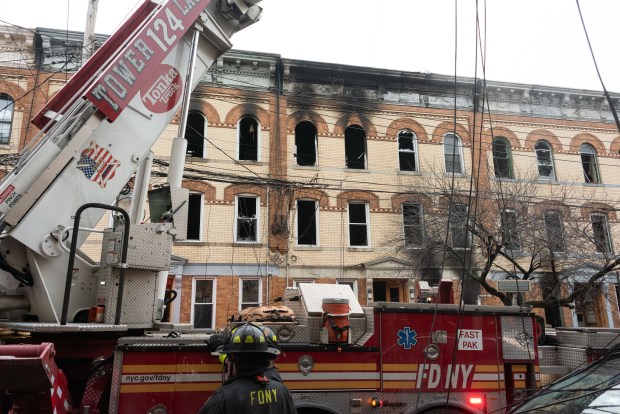Firefighters work on a five-alarm fire in a row of apartment buildings on Madison St. near Onderdonk Ave. in Ridgewood, Queens, on Tuesday, Jan. 6, 2025. (Gardiner Anderson / New York Daily News)