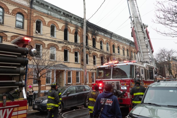 Firefighters work on a five-alarm fire in a row of apartment buildings on Madison St. near Onderdonk Ave. in Ridgewood, Queens, on Tuesday, Jan. 6, 2025. (Gardiner Anderson / New York Daily News)