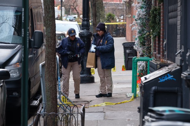 Police investigate an officer-involved shooting on Bedford St. and Downing St. in Manhattan.