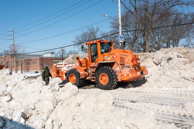 Department of Sanitation workers melt snow at a site in Red Hook, Brooklyn on Thursday, January 29, 2026. DSNY set up the machines, which can melt up to 120 tons of snow per hour, at eight locations in the five boroughs. (Gardiner Anderson / New York Daily News)