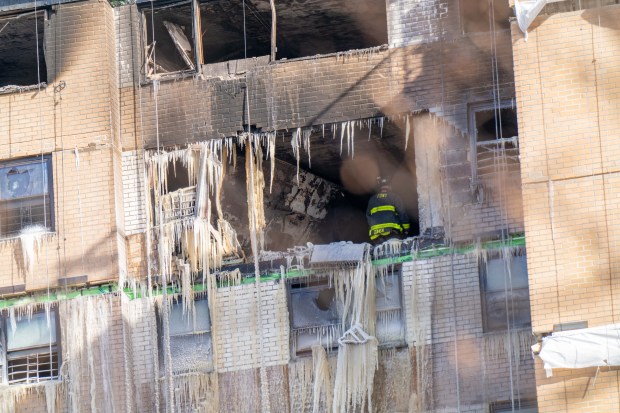 A partially destroyed apartment building is pictured after a massive fire tore through the top of a Bronx NYCHA high-rise on Bivona St. near Reeds Mill Lane in the Bronx early Saturday, Jan. 24, 2026. (Theodore Parisienne / New York Daily News)