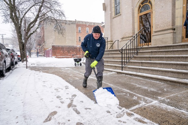 A man shoveling snow near Martha Avenue and East 241st Street in the Bronx on Sunday, January 18, 2026. (Theodore Parisienne / New York Daily News)