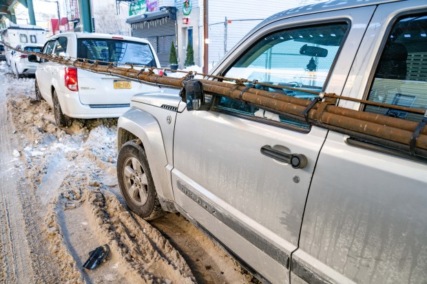 A bundle of communication wires that fell from the elevated subway tracks above Fulton St. between Linwood St. and Elton St. in Cypress Hill, Brooklyn, damaged six cars on Friday, Jan. 30, 2026. (Theodore Parisienne / New York Daily News)