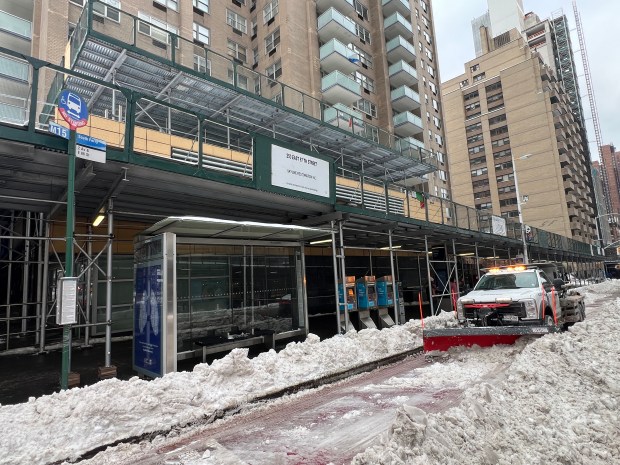 A Department of Sanitation worker plows out a bus stand on the corner of E. 86th St. and 2nd Ave. Monday, January 26, 2026, in Manhattan, New York. (Barry Williams/ New York Daily News)