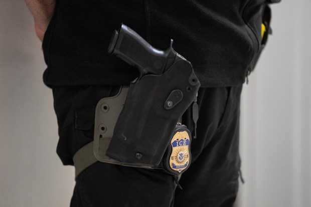 An ICE officer outside an immigration courtroom at the Javits Federal Building.
