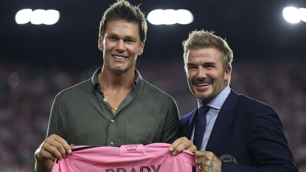 Aug 24, 2024; Fort Lauderdale, Florida, USA; Inter Miami president and co-owner David Beckham presents a jersey to former NFL player Tom Brady during the match between the FC Cincinnati and the Inter Miami at Chase Stadium. Mandatory Credit: Nathan Ray Seebeck-Imagn Images