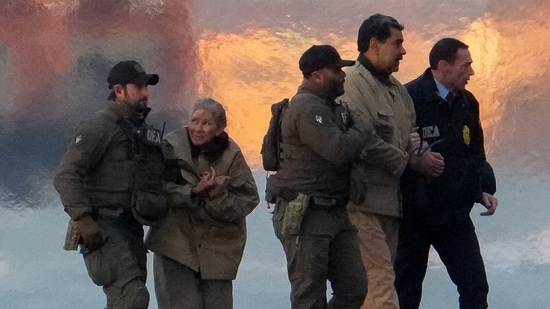 Venezuelan President Nicolas Maduro and his wife Cilia Flores moved out of a helicopter, as Maduro heads towards the Daniel Patrick Manhattan United States Courthouse for an initial appearance to face U.S. federal charges including narco-terrorism, conspiracy, drug trafficking, money laundering and others in New York City, U.S., January 5, 2026. REUTERS/Adam Gray(REUTERS)