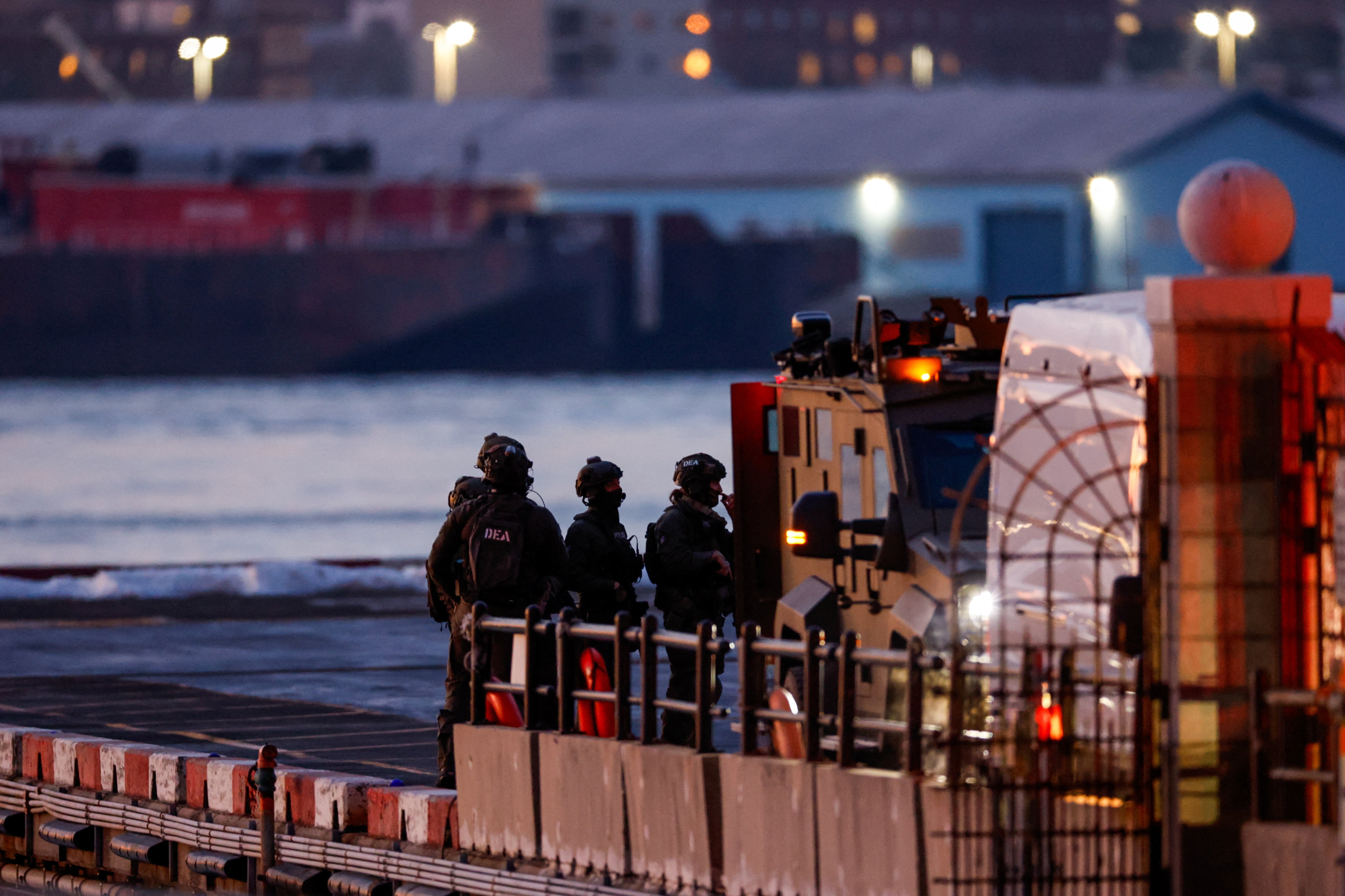 DEA (Drug Enforcement Administration) agents wait for the arrival of captured Venezuelan President Nicolas Maduro at the Downtown Manhattan Heliport.(REUTERS)