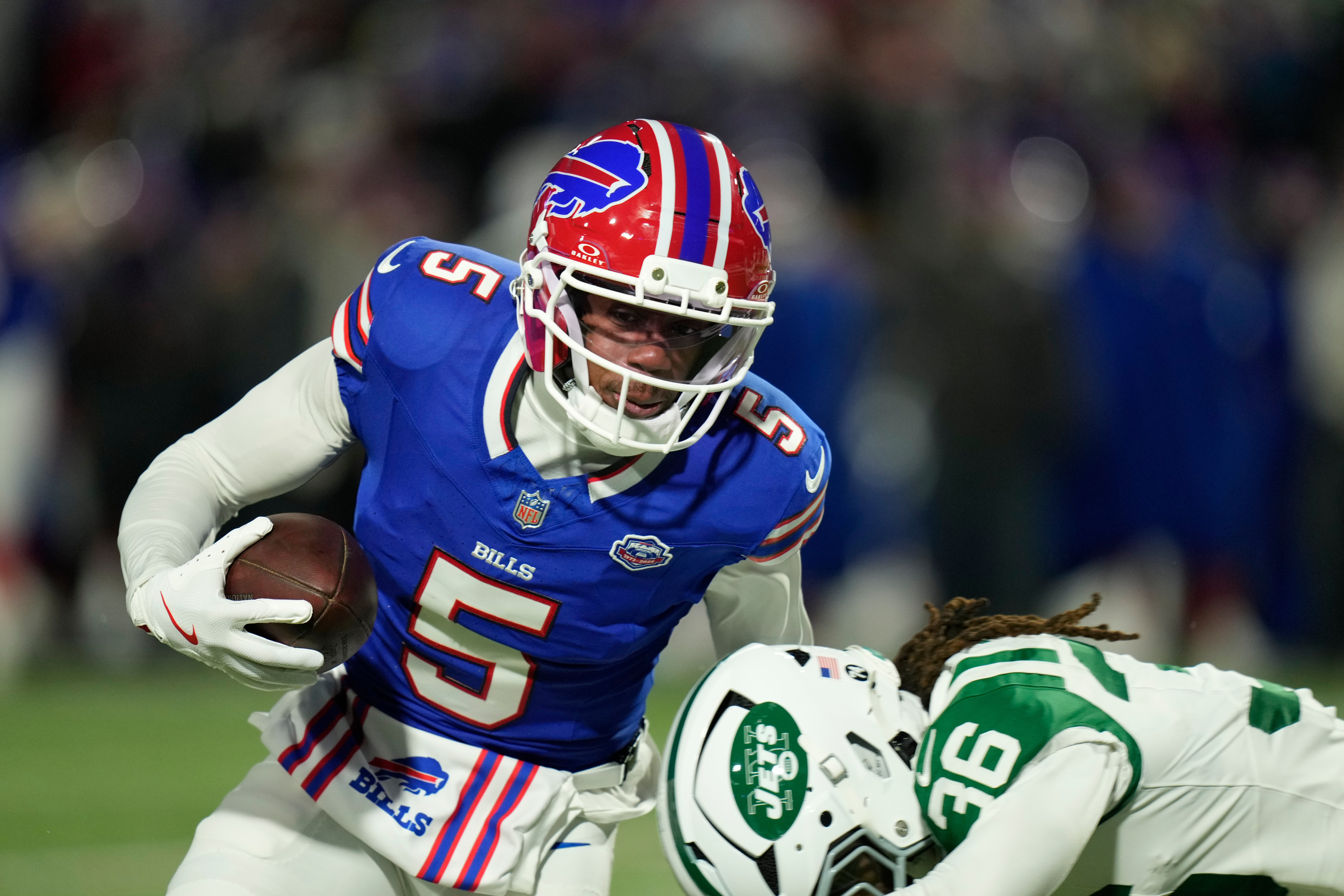 Buffalo Bills wide receiver Joshua Palmer (5) carries the ball against New York Jets cornerback Ja'sir Taylor (36) in the first half of an NFL football game Sunday, Jan. 4, 2026, in Orchard Park, N.Y. (AP Photo/Seth Wenig)