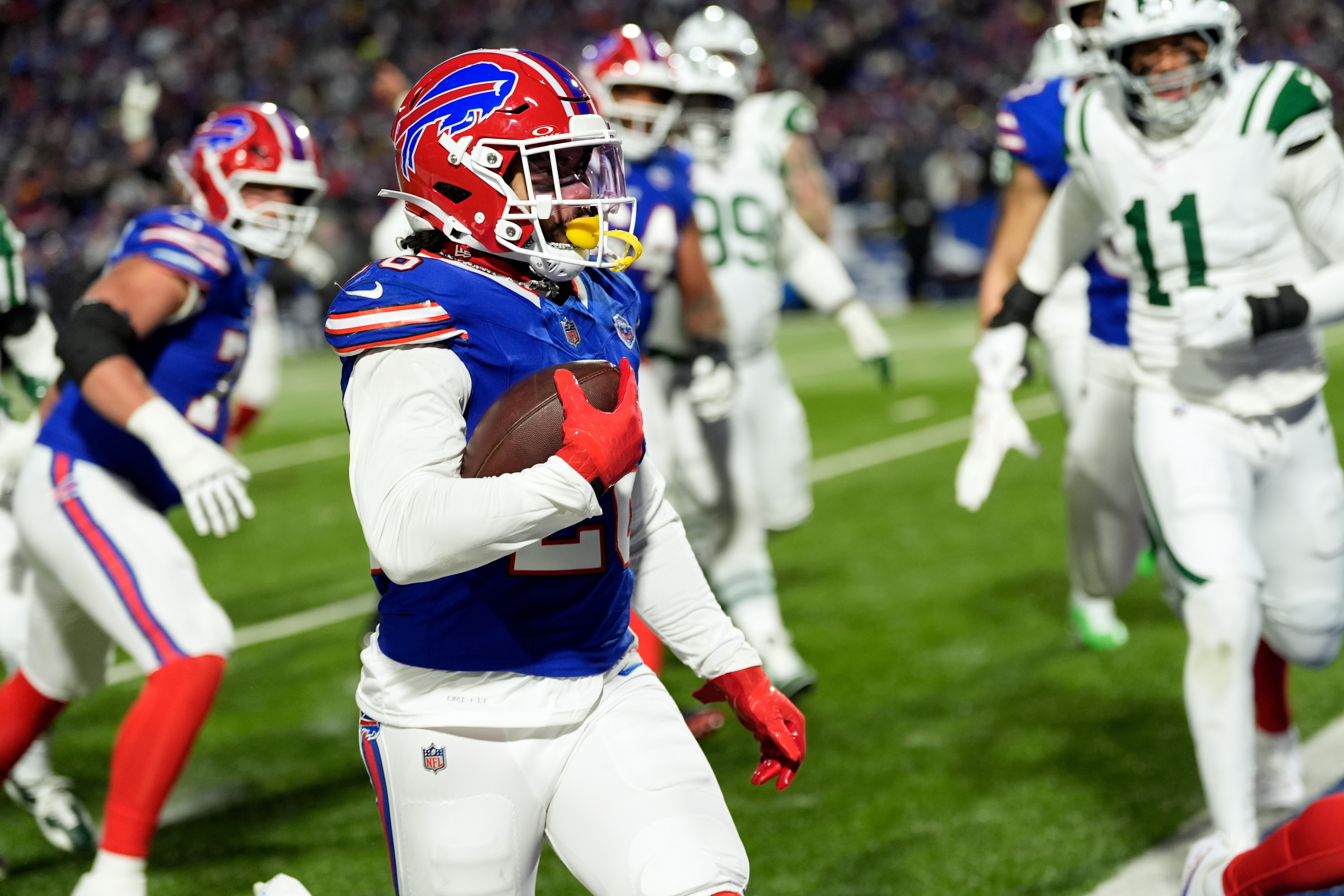 Buffalo Bills running back Ty Johnson (26) carries the ball for a touchdown against the New York Jets in the first half of an NFL football game Sunday, Jan. 4, 2026, in Orchard Park, N.Y. (AP Photo/Seth Wenig)