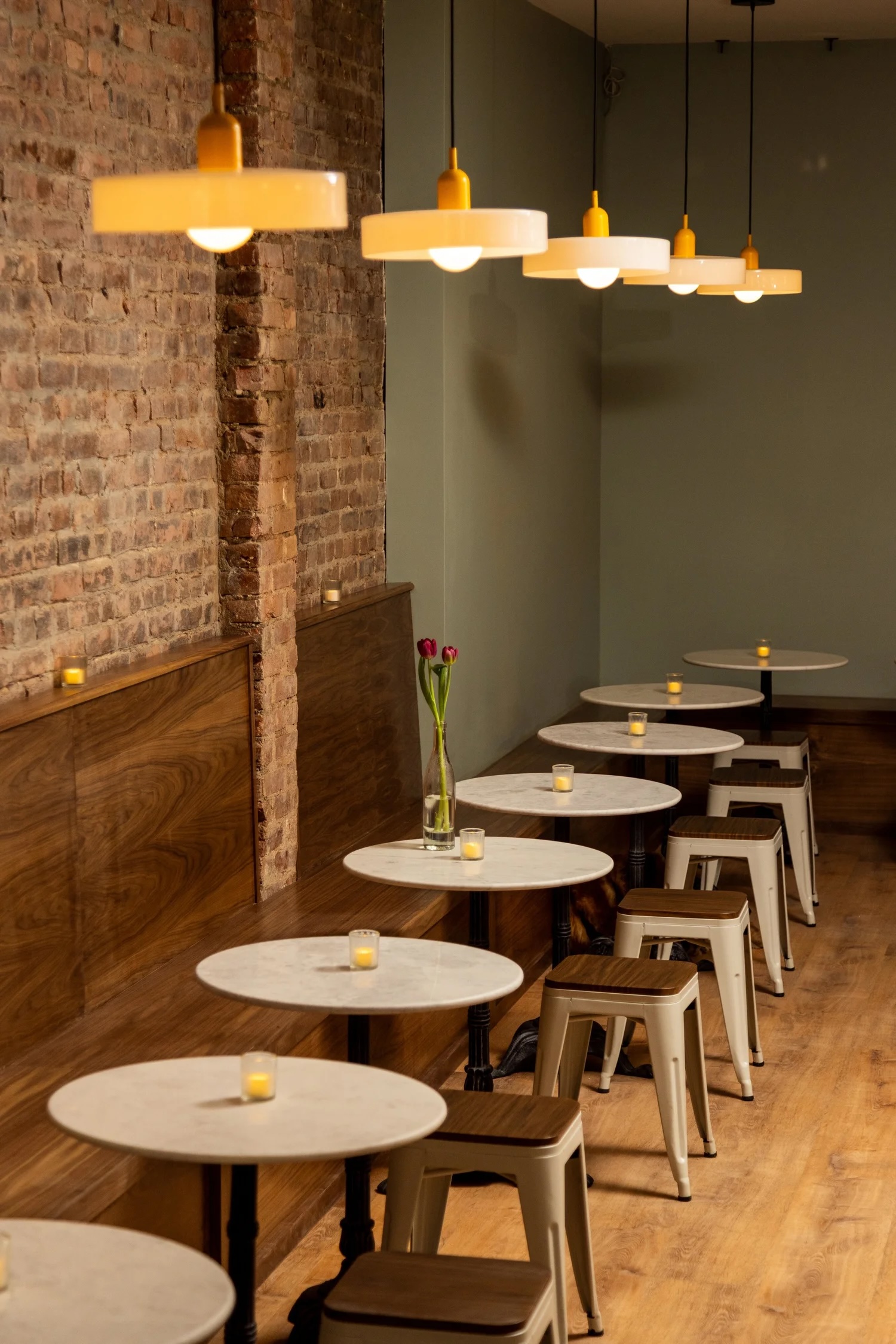 A restaurant with table seating along the wall.