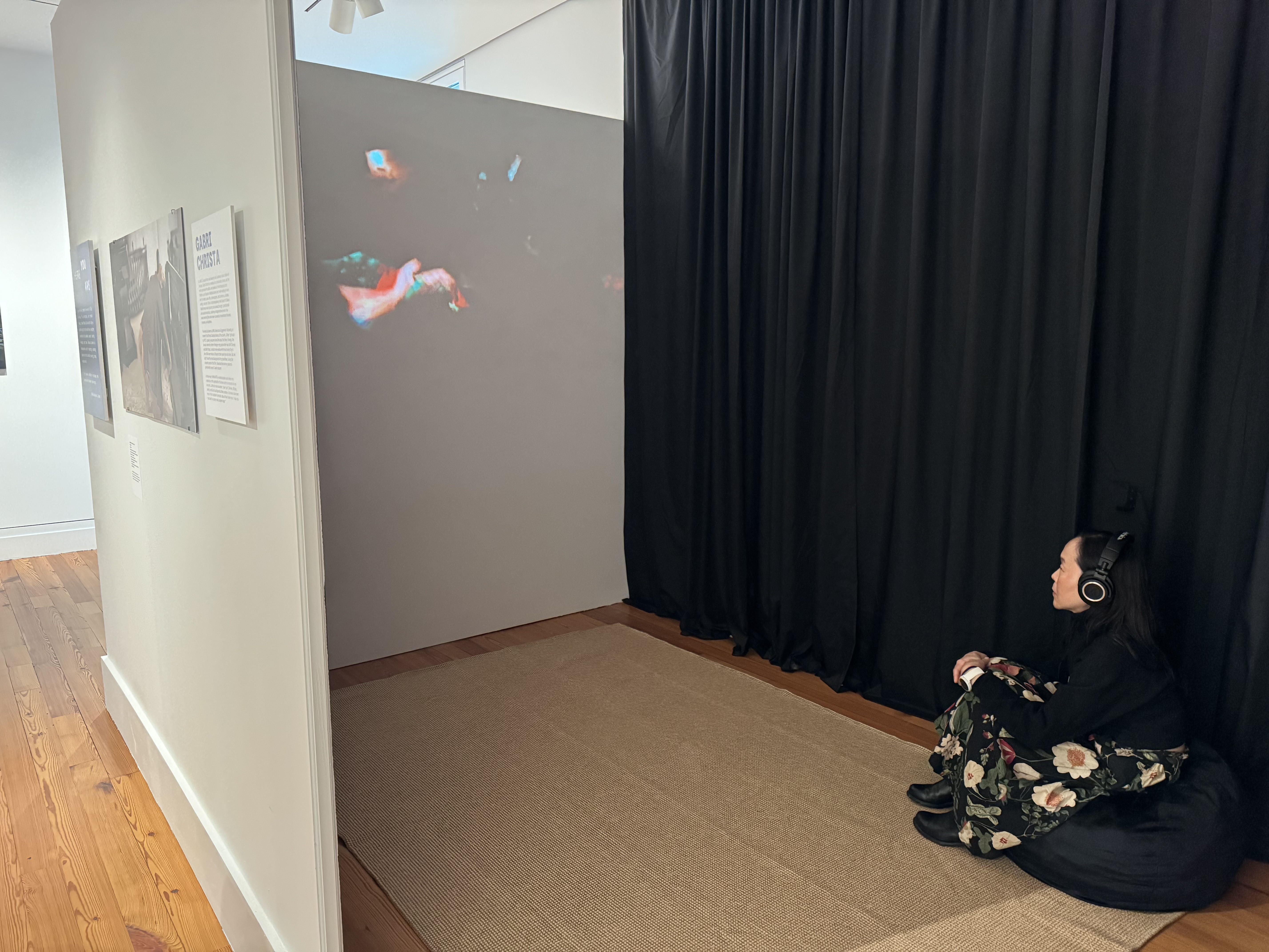 Siobhan McBride watches fellow artist Gabi Christa's film at the Staten Island Museum triennial exhibit