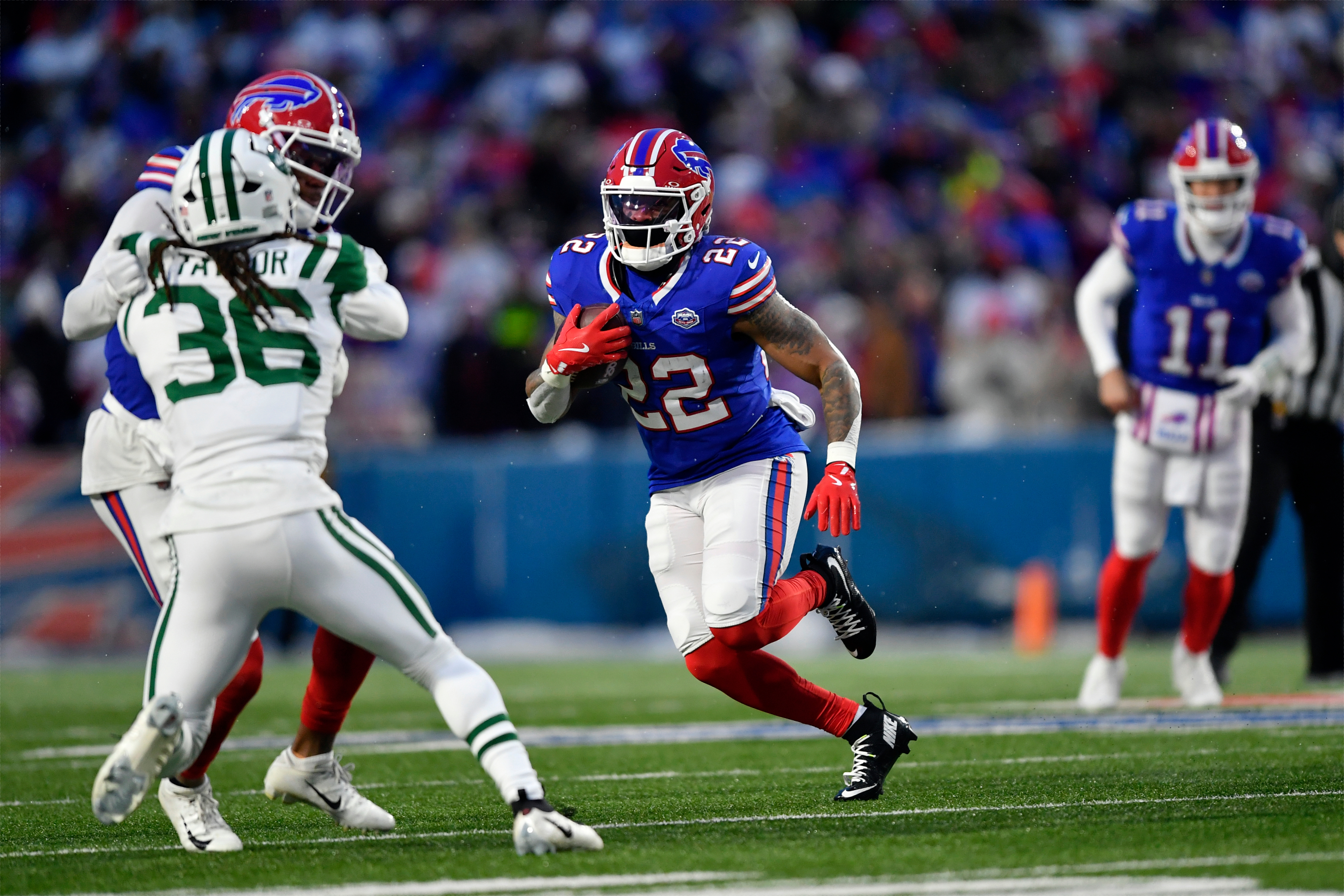 Buffalo Bills running back Ray Davis (22) tries to get past New York Jets cornerback Ja'sir Taylor (36) in the first half of an NFL football game Sunday, Jan. 4, 2026, in Orchard Park, N.Y. (AP Photo/Adrian Kraus)