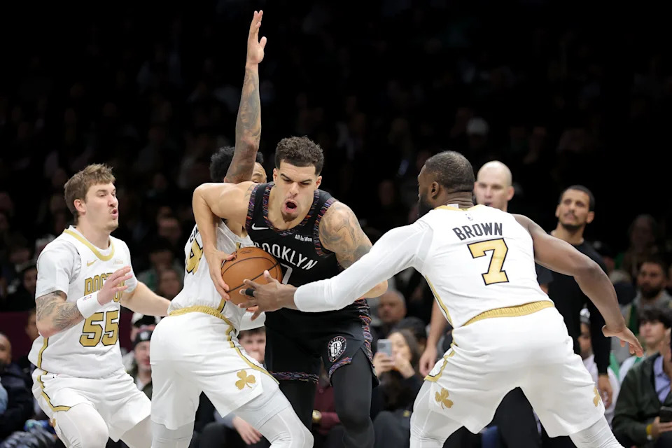 Jan 23, 2026; Brooklyn, New York, USA; Brooklyn Nets forward Michael Porter Jr. (17) controls the ball against Boston Celtics guards Baylor Scheierman (55) and Anfernee Simons (4) and Jaylen Brown (7) during the fourth quarter at Barclays Center. Mandatory Credit: Brad Penner-Imagn Images