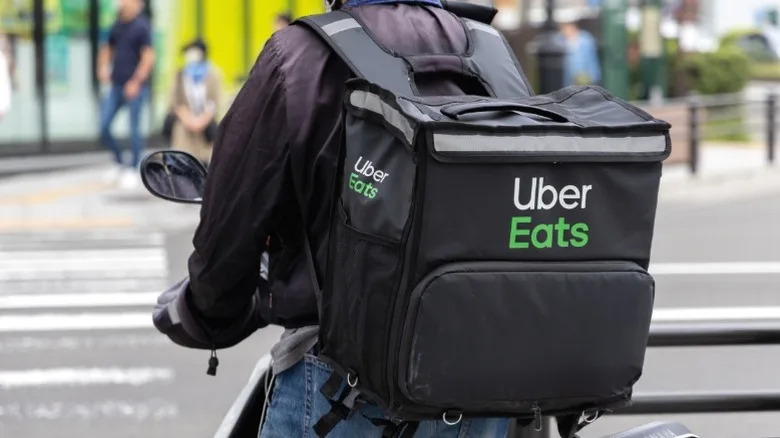 An Uber Eats delivery driver on a bike.