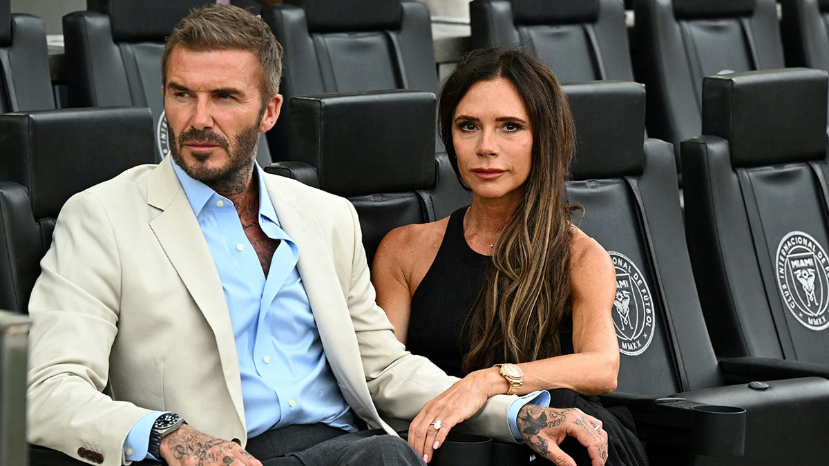 Victoria Beckham and David Beckham posing for the camera