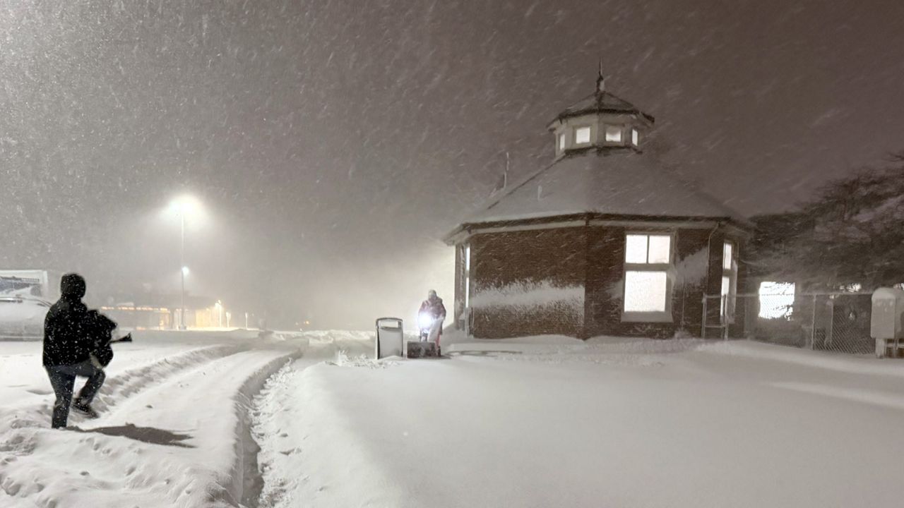 angola rest stop on thruway snowed in, with someone plowing walkway