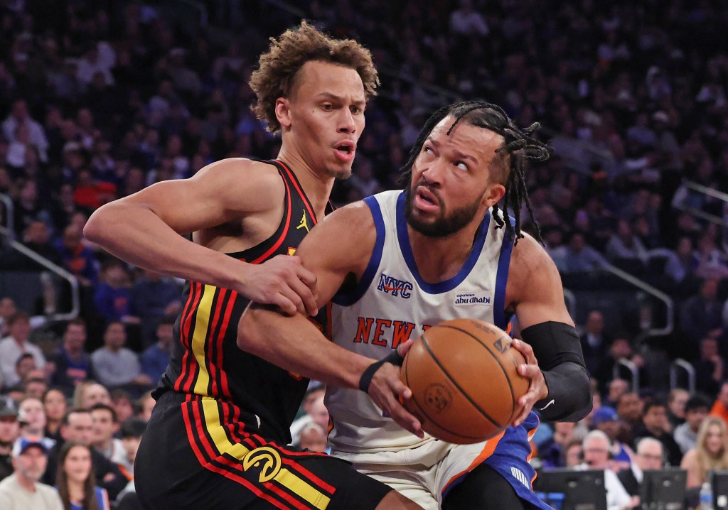 New York Knicks guard Jalen Brunson #11 drives to the basket as Atlanta Hawks guard Dyson Daniels #5 defends.