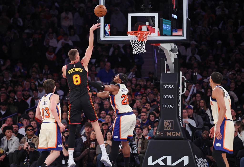 Atlanta Hawks center Kristaps Porzingis #8 shoots over New York Knicks forward Guerschon Yabusele #28.
