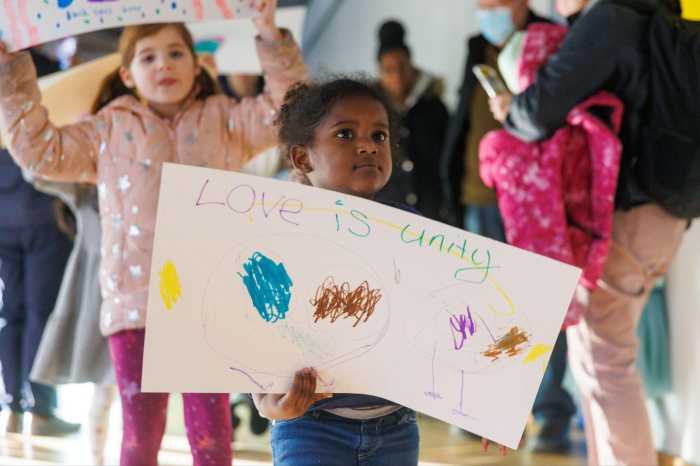 kids with protest signs at martin luther king jr. day at BCM