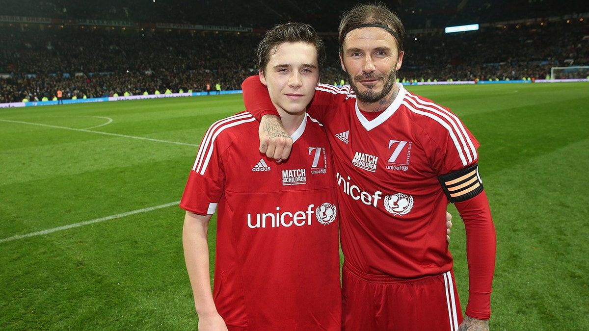 Brooklyn Beckham and David Beckham pose for a photo at the Match for Children in aid of UNICEF in November 2015.