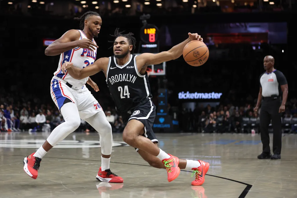 Brooklyn Nets guard Cam Thomas (24) is defended by Philadelphia 76ers forward Jabari Walker (33) during the first half of a game at Barclays Center.