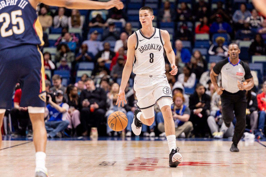 Brooklyn Nets guard Egor Dëmin dribbling the ball against New Orleans Pelicans forward Trey Murphy III.