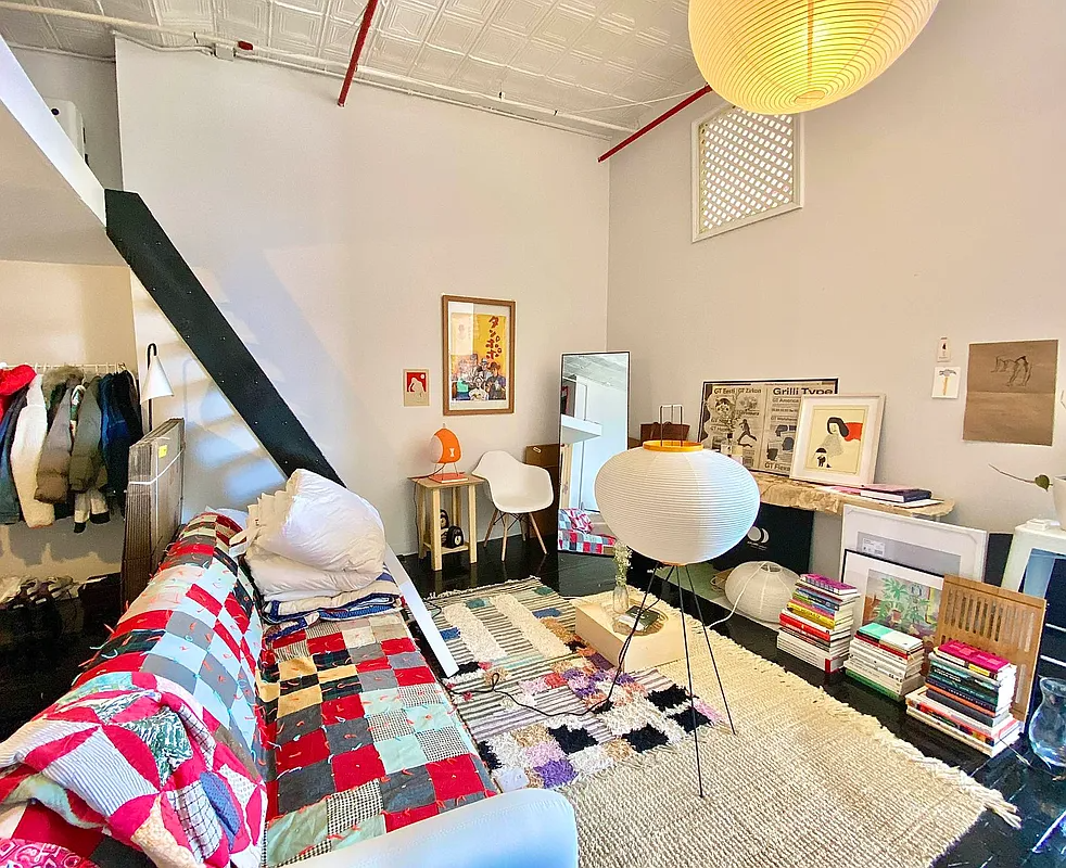 living area with ladder to loft