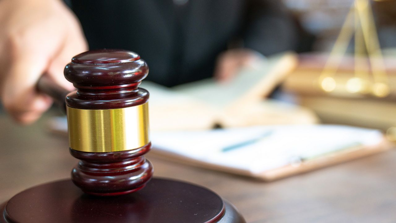 judge bangs gavel on stand