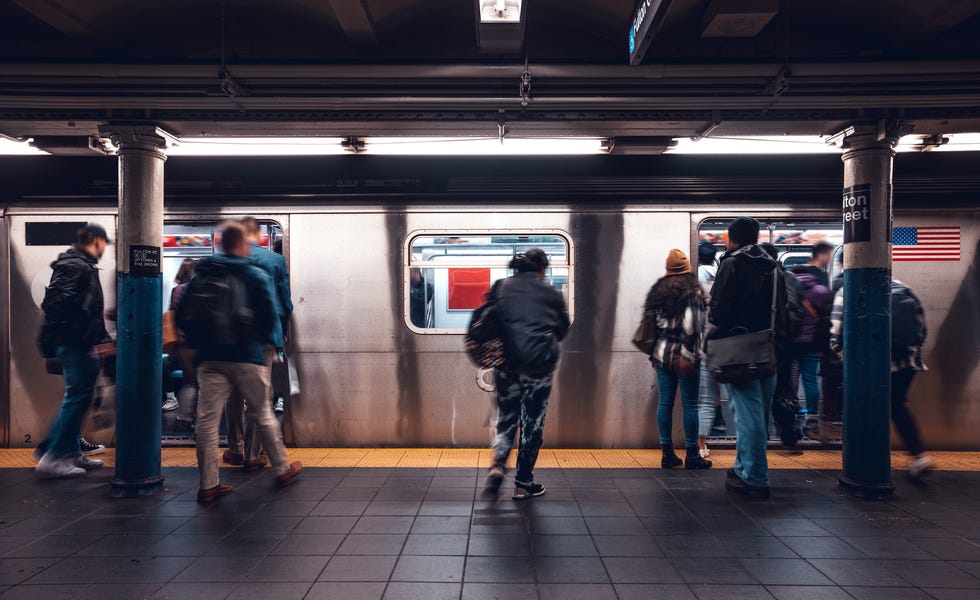 crowd of people in a nyc subway station waiting for the train
