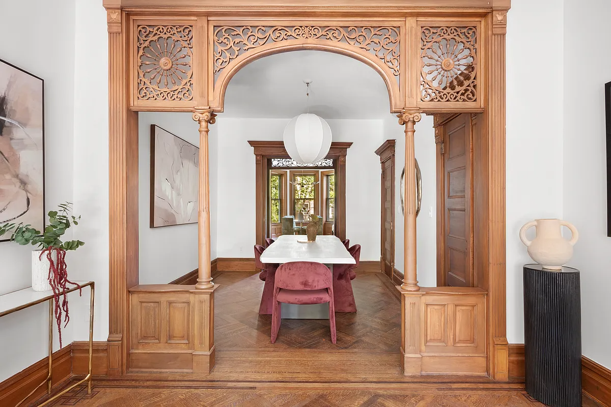 a fretwork screen dividing a front and middle parlor